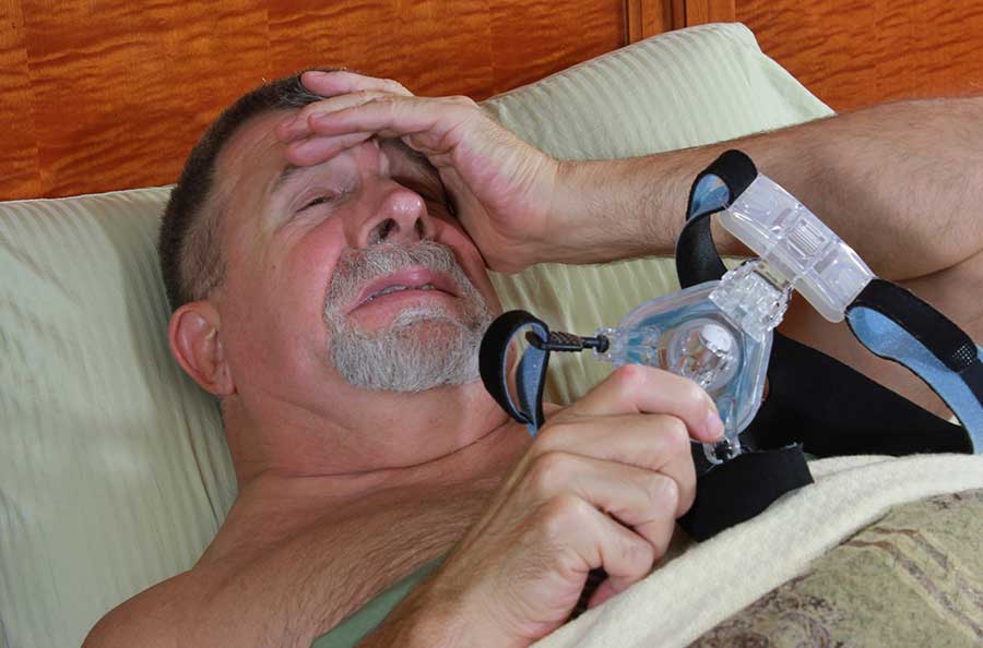 man suffering from CPAP machine side effects